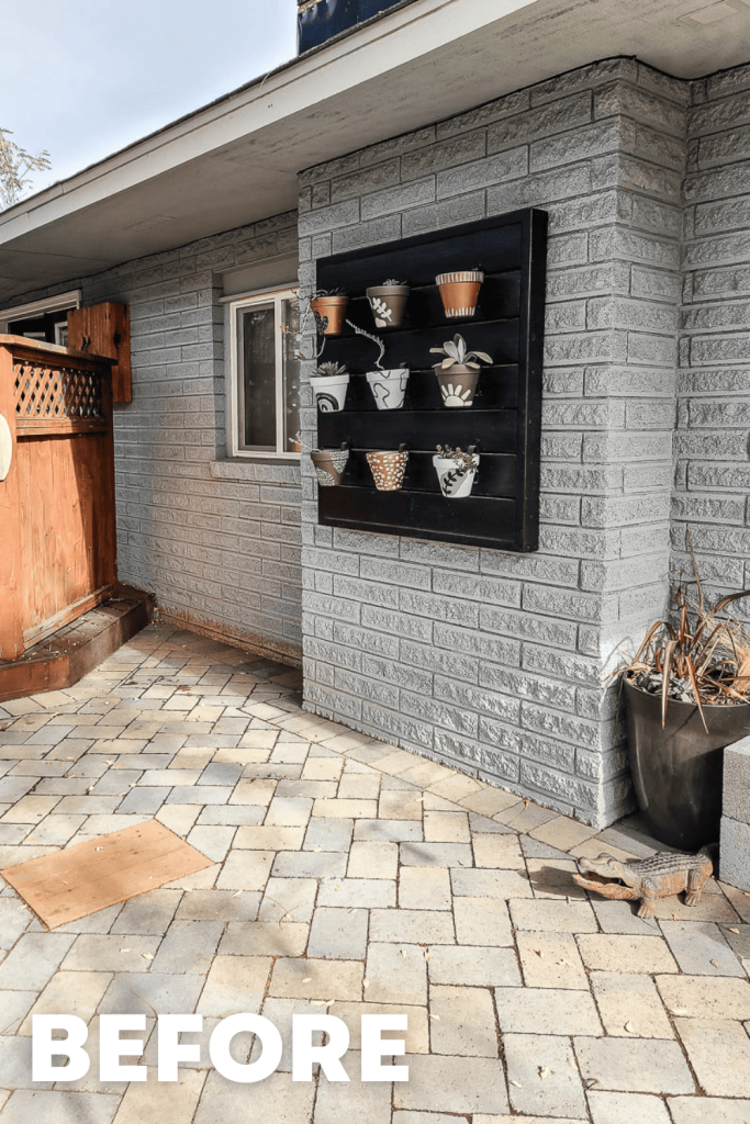 the photo shows nine pots hanging on a wall made of bricks.