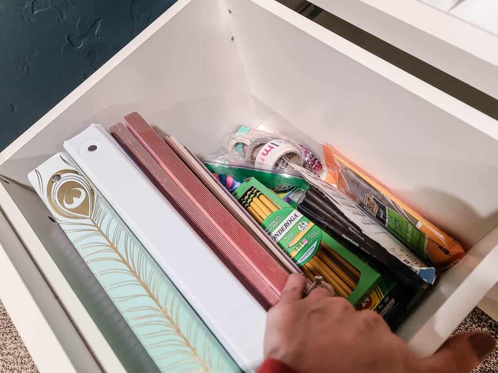 Neatly organized bottom drawers filled with an array of essential school supplies, offering a convenient and accessible storage solution for a productive learning environment.