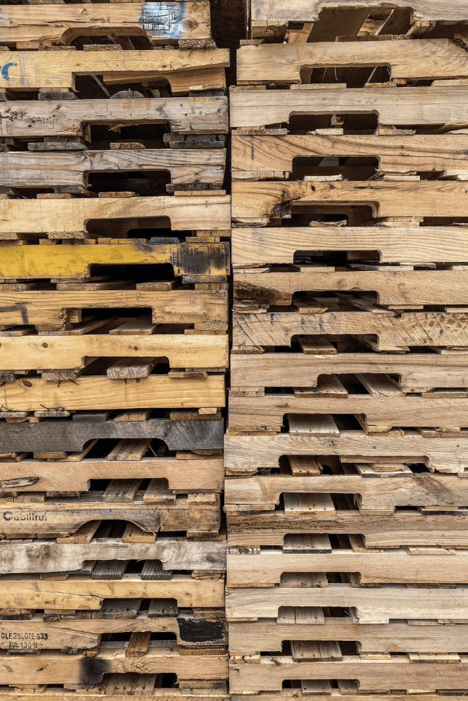 A supply of pallet wood that can be used to make a simple DIY Pallet Shelf.