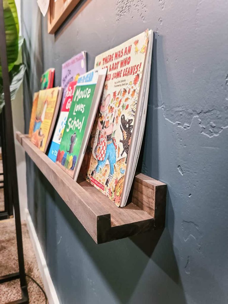 DIY built in ledge shelf displaying some texbooks.