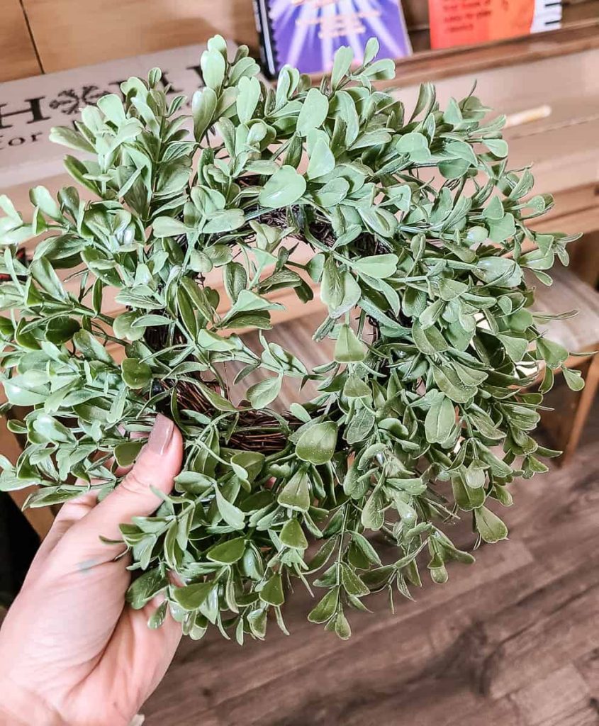 A close-up photo of a small wreath being held by the person