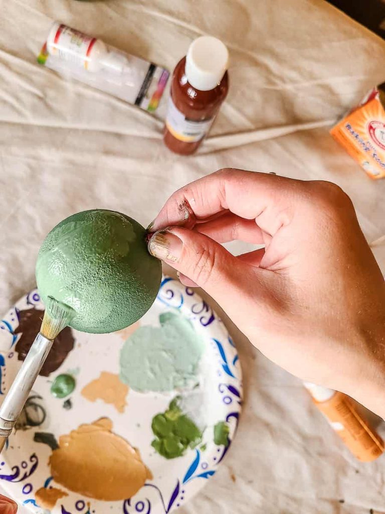 The next photo showed that the person had coated one ornament with a second coat of paint.
