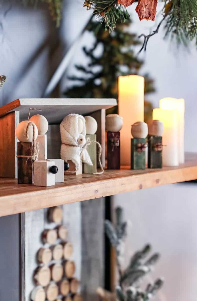 A group of handmade wooden dolls, dressed in a festive Christmas theme a DIY Wood Nativity Scene.