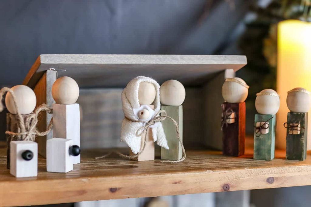 The photo shows a scene made of wood that depicts Mary and Joseph with the baby Jesus a DIY Wood Nativity Scene
