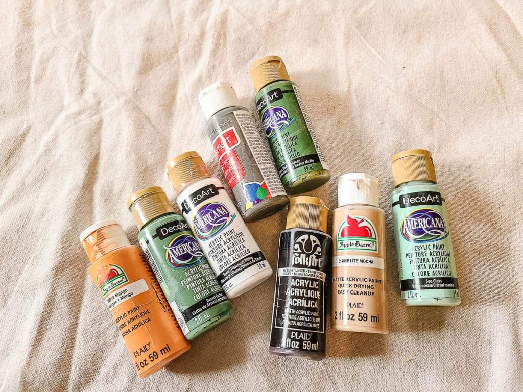 A photo of 8 different acrylic paints that are used to paint ornaments.