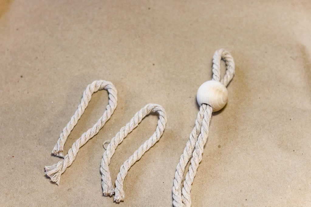 Macrame cord with a wooden bead for the head of a Christmas tree ornament.