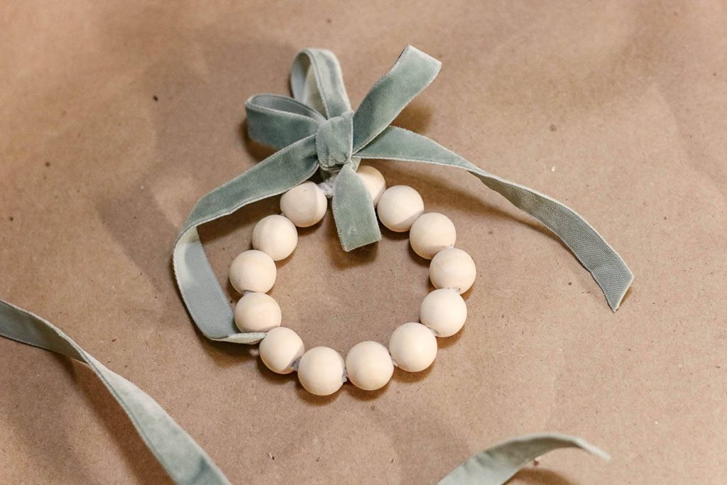 Tie pipe cleaners into a circular shape, attaching them with green velvet ribbon.