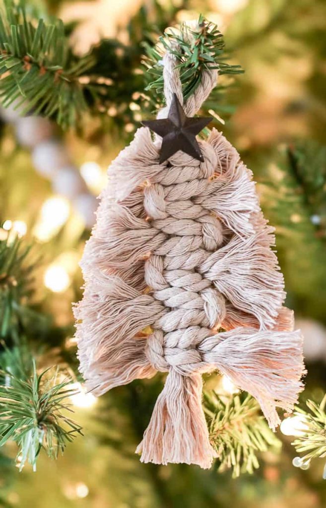 A photo of a Macrame Christmas Ornament Tree hangs on the tree.