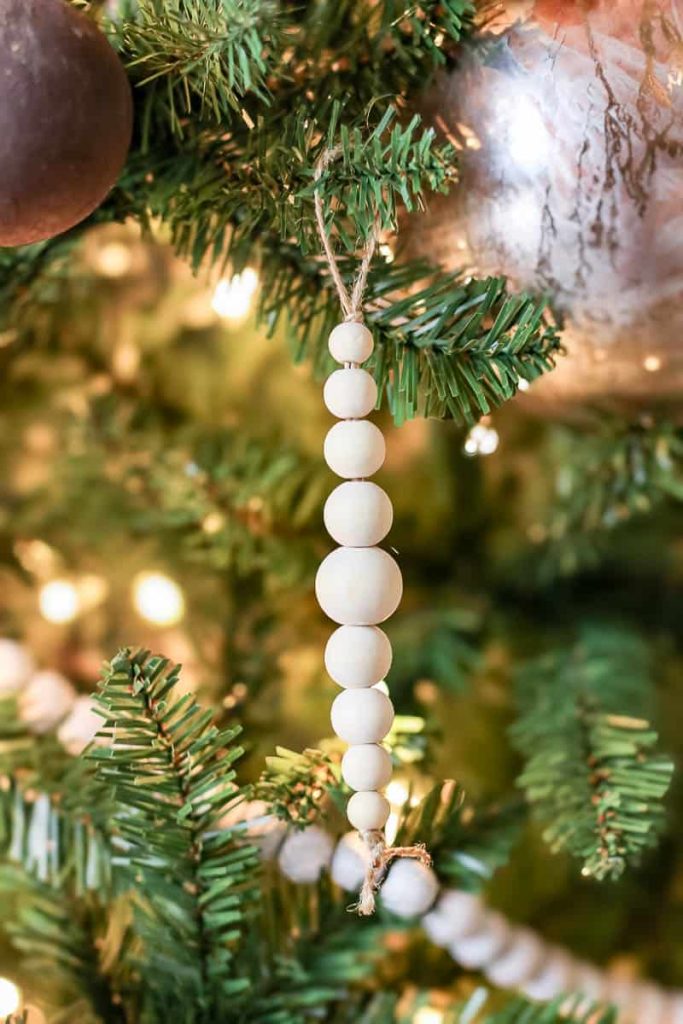 A close-up view of a Christmas tree adorned with a delightful assortment of bead ornaments, showcasing a vibrant mix of colors and shapes for a festive and eclectic holiday display