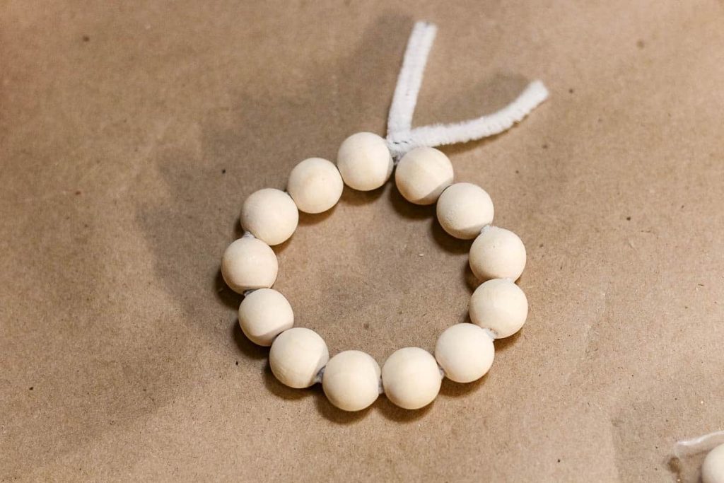 Tie pipe cleaners into a small circle to make a mini wreath.