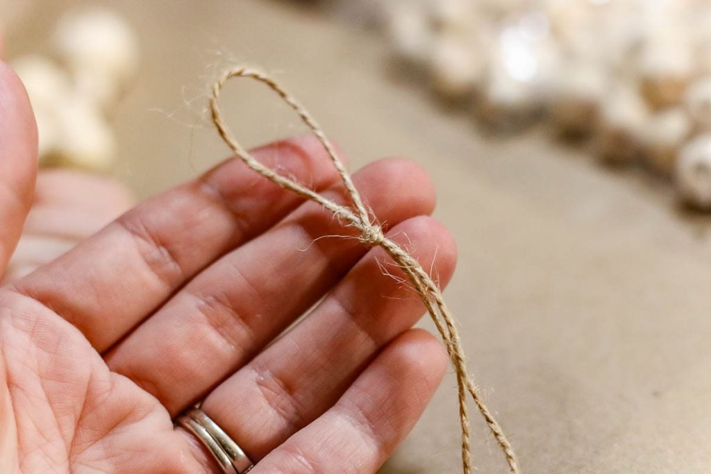 A person hands with twine knot