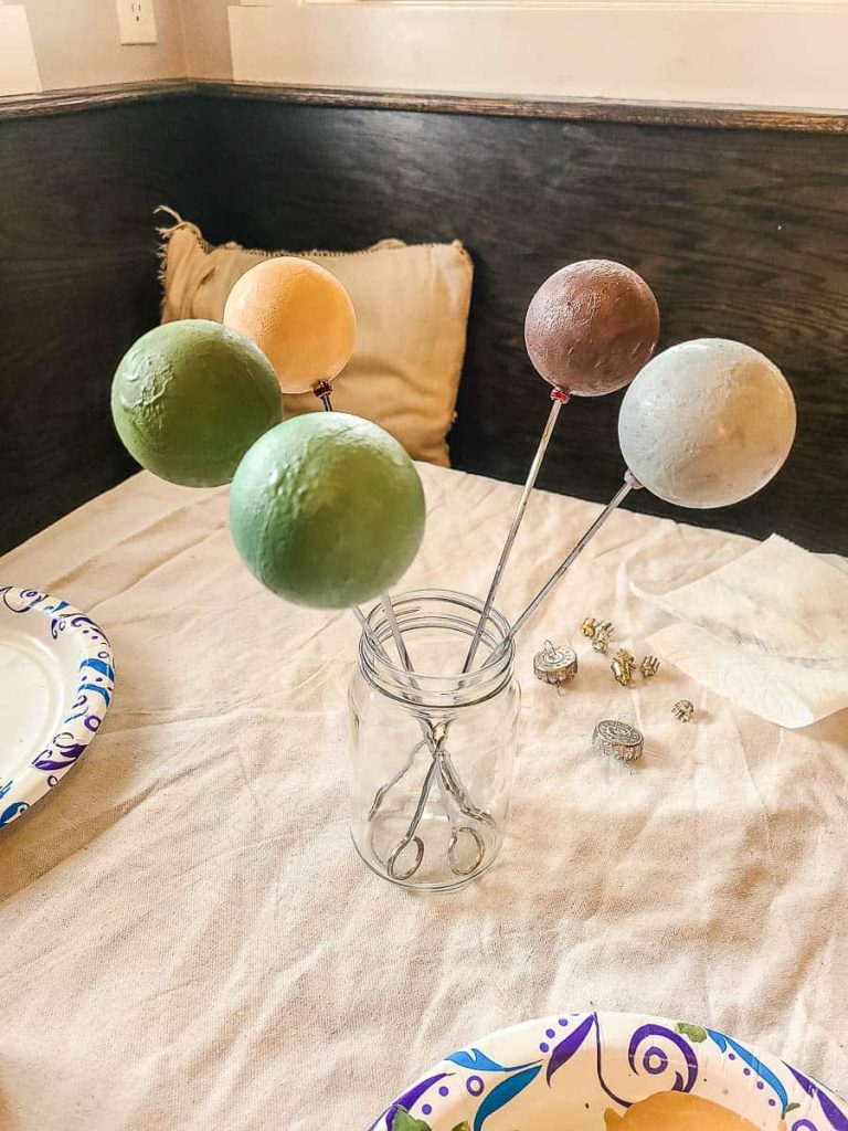 Paint five ornaments and dry them