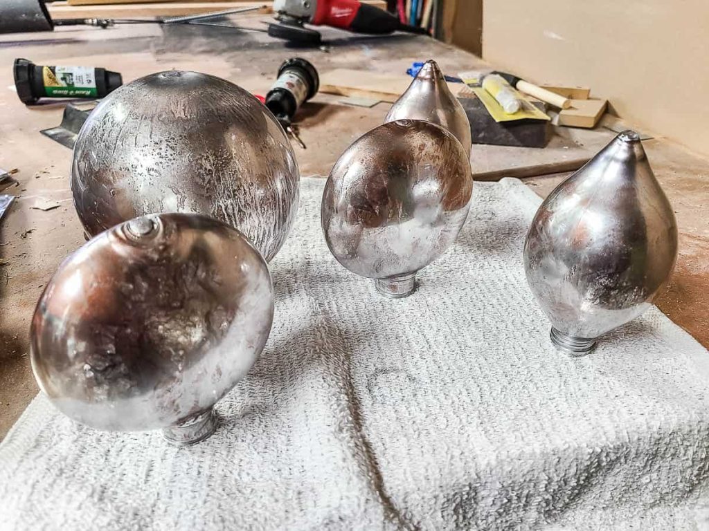 A Mercury Glass Christmas ornament sits on a towel to dry.