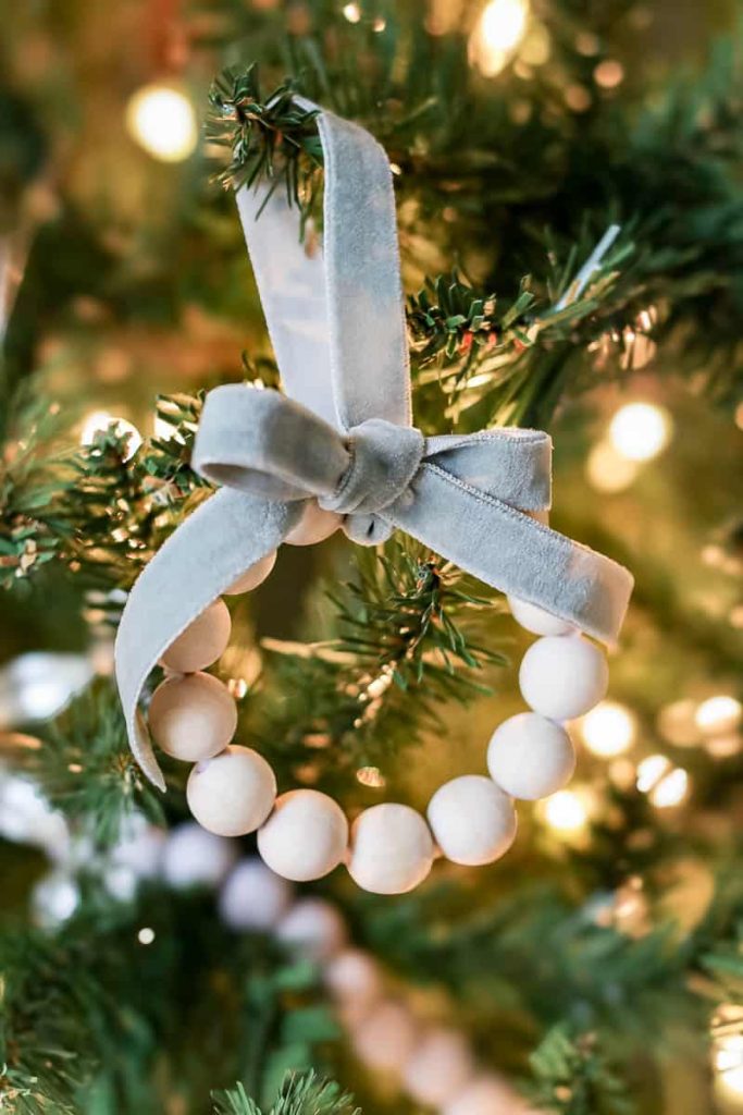 Detailed shot capturing the beauty of various bead ornaments meticulously placed on a Christmas tree, adding a colorful and lively charm to the festive decorations.