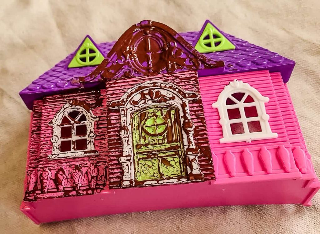 Dollhouse with an acrylic paint base before trying primer and the paint is not beading up in the surface and not sticking