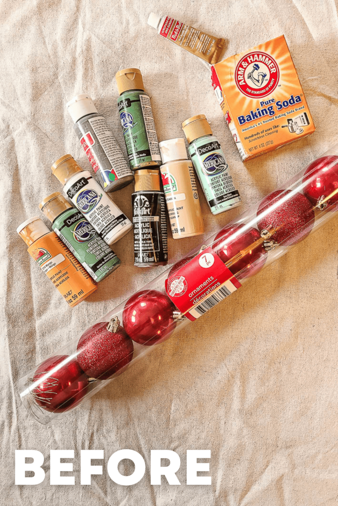 A photo of materials: a red Christmas ball, baking soda, and paintbrush.