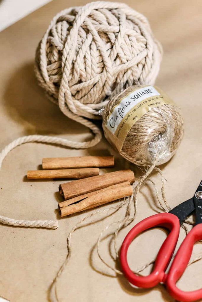 Supplies needed to make a cinnamon stick ornament that can be used as a Christmas tree decoration.
