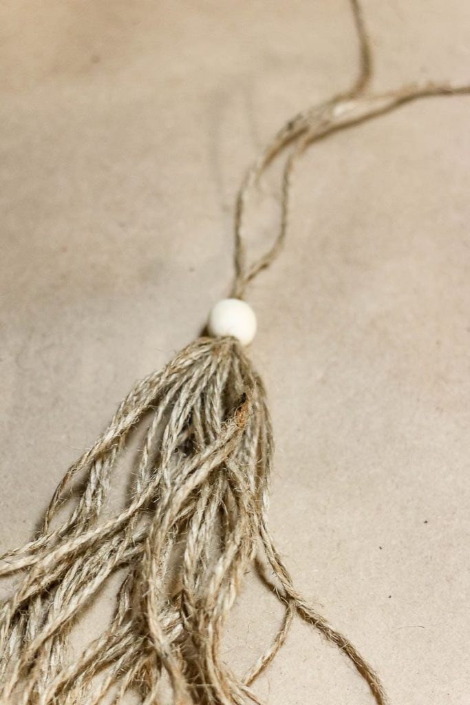 A twine with a wooden bead attached.