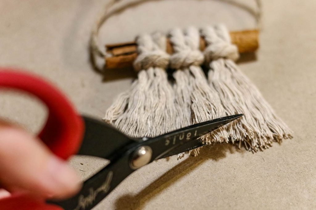 A photo of the macrame cord being cut with scissors.