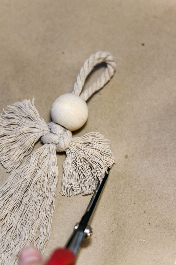 An angel-style Christmas ornament, after being unraveled and cut with scissors, looks like this.