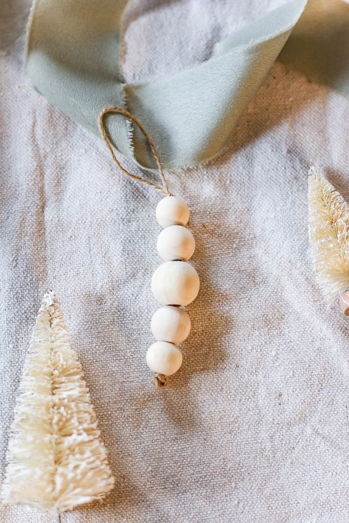 another photo shows beads made of wood on the twine