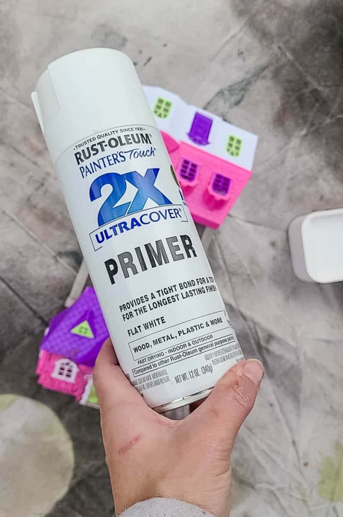 DIY gingerbread house project essentials: Primer for a smooth base, ensuring perfect adherence and lasting holiday charm.