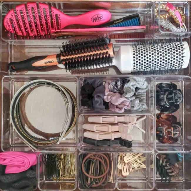 Small clear bins used by Polished Habit for organizing small hair products, demonstrating a practical and transparent storage solution for easy access and a tidy space.