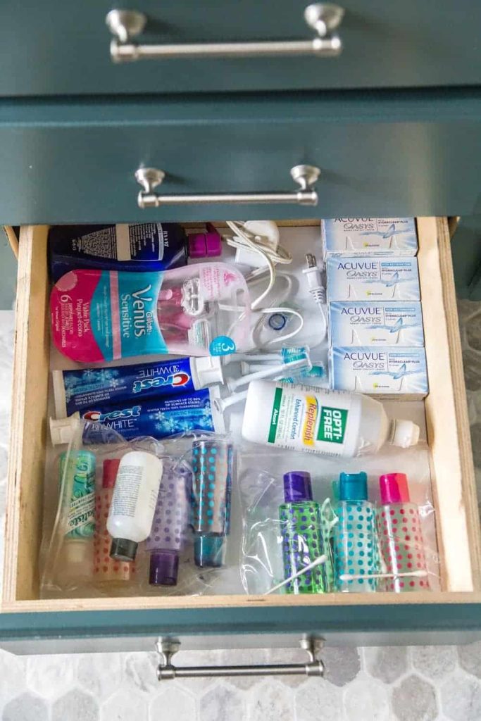 A bottom drawer impeccably organized with various items, showcasing a systematic and clutter-free storage arrangement for easy access and a tidy living space.