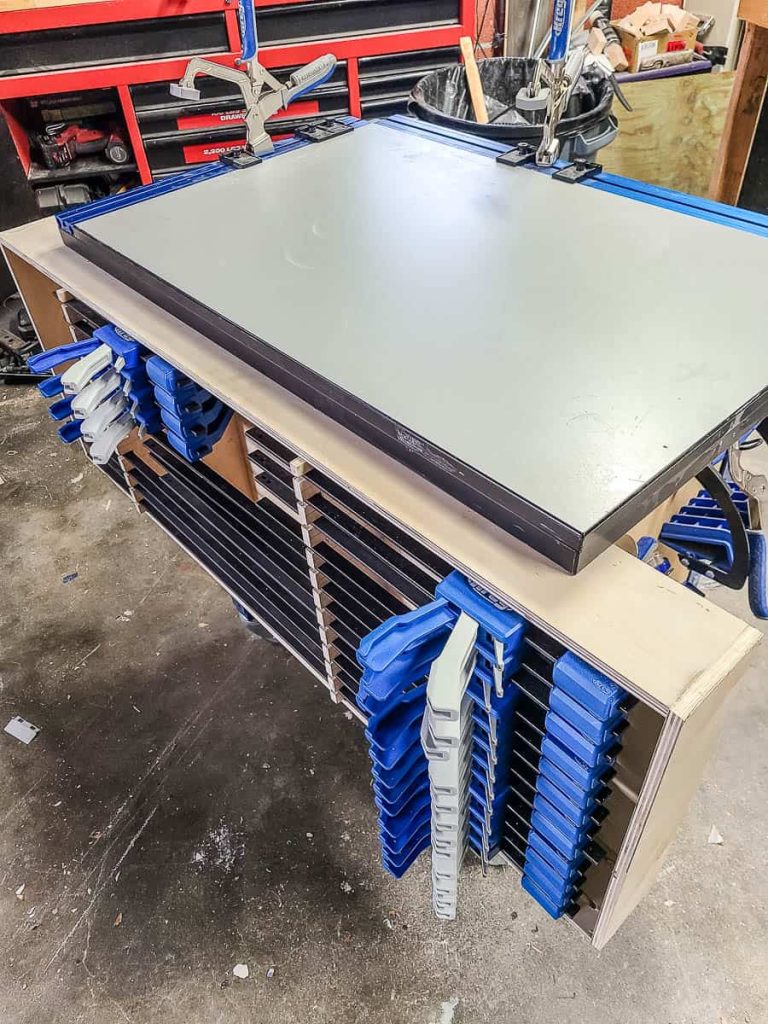 DIY clamp rack mounted on the wall.