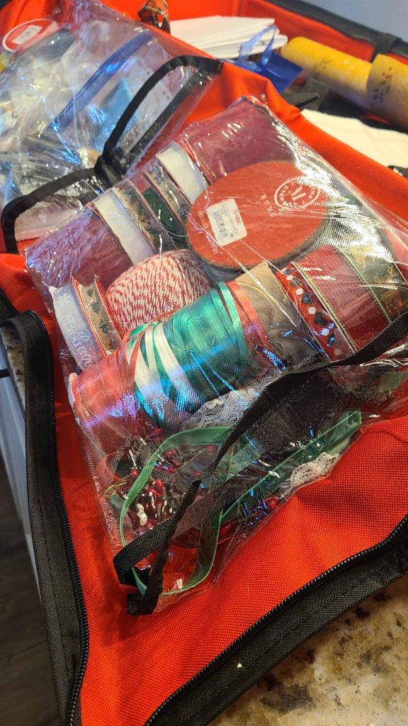 Admire the systematic arrangement of gift ribbons and bags, showcasing an organized and efficient approach to creating beautifully wrapped gifts effortlessly,