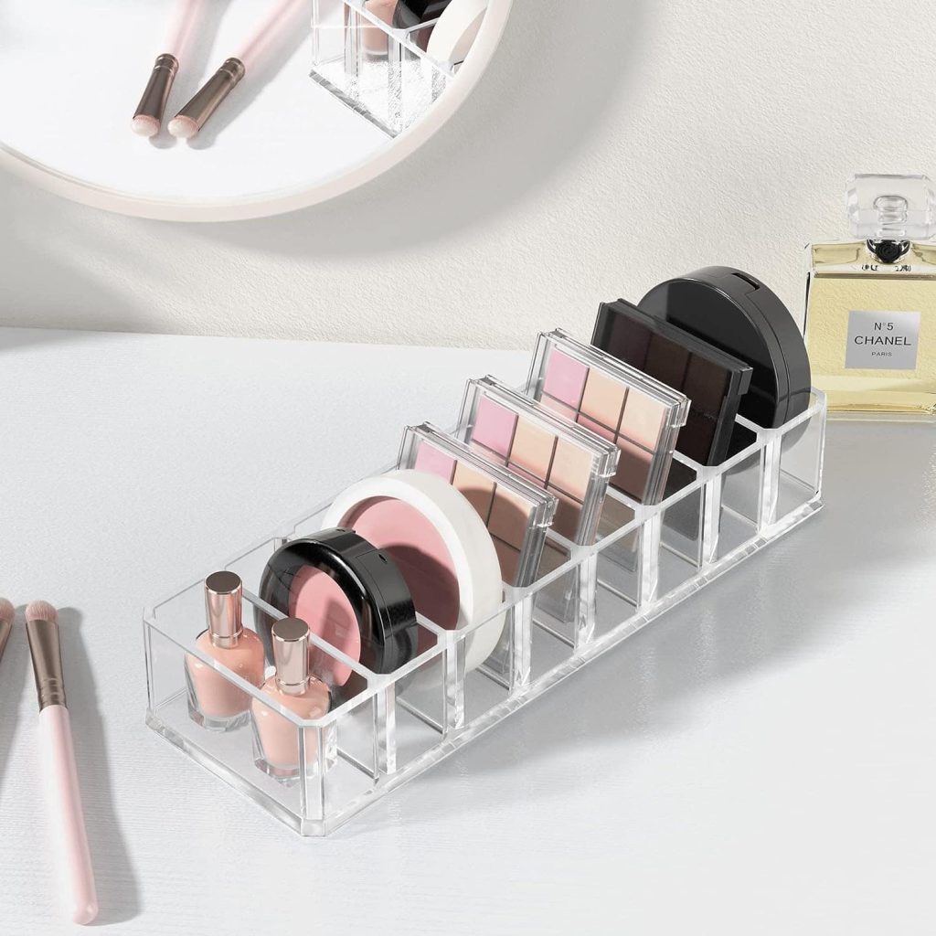 Makeup compacts neatly stored in an acrylic organizer, showcasing a tidy and visually pleasing arrangement for easy accessibility and efficient makeup storage.