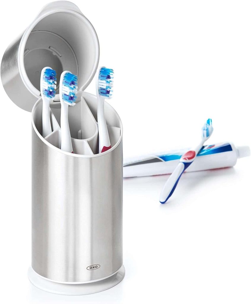 A toothbrush in a holder with a lid, promoting hygiene and protection against contaminants, enhancing the overall cleanliness of the dental care.