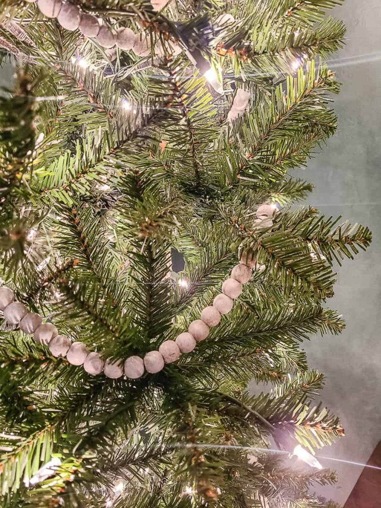 Boho-inspired Christmas branches adorned with enchanting decor and twinkling lights, offering a festive and whimsical glimpse into a uniquely styled holiday setting.