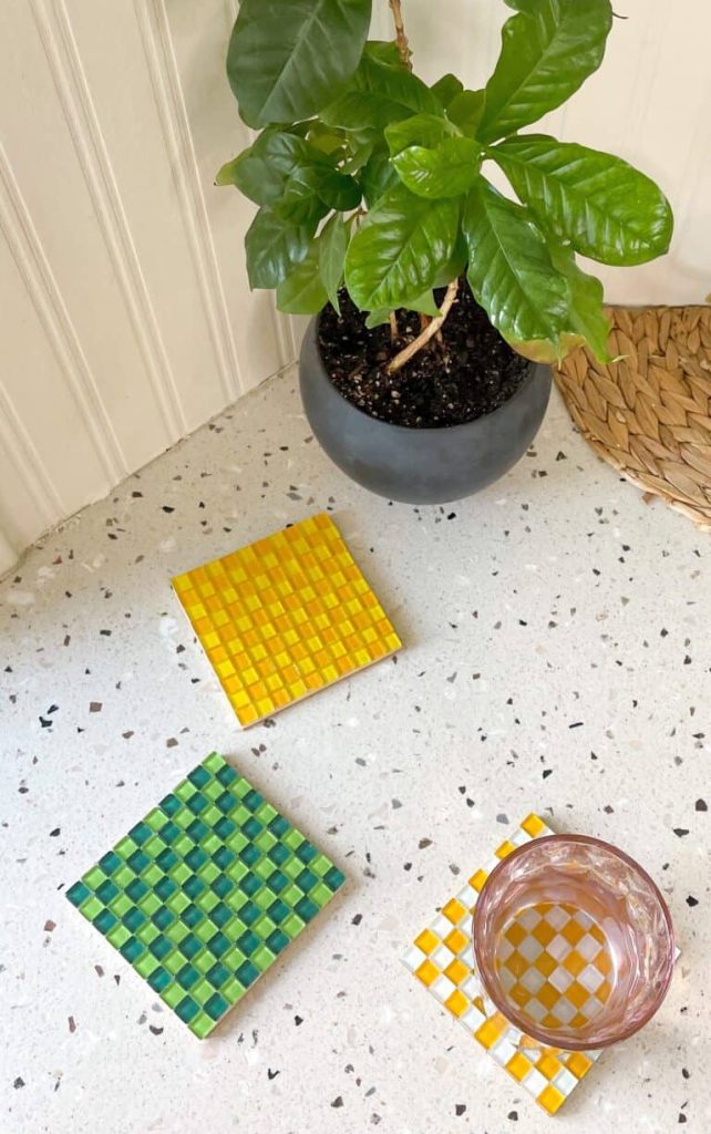 Checkered Tile Coasters sitting on countertop with plant and glass of water