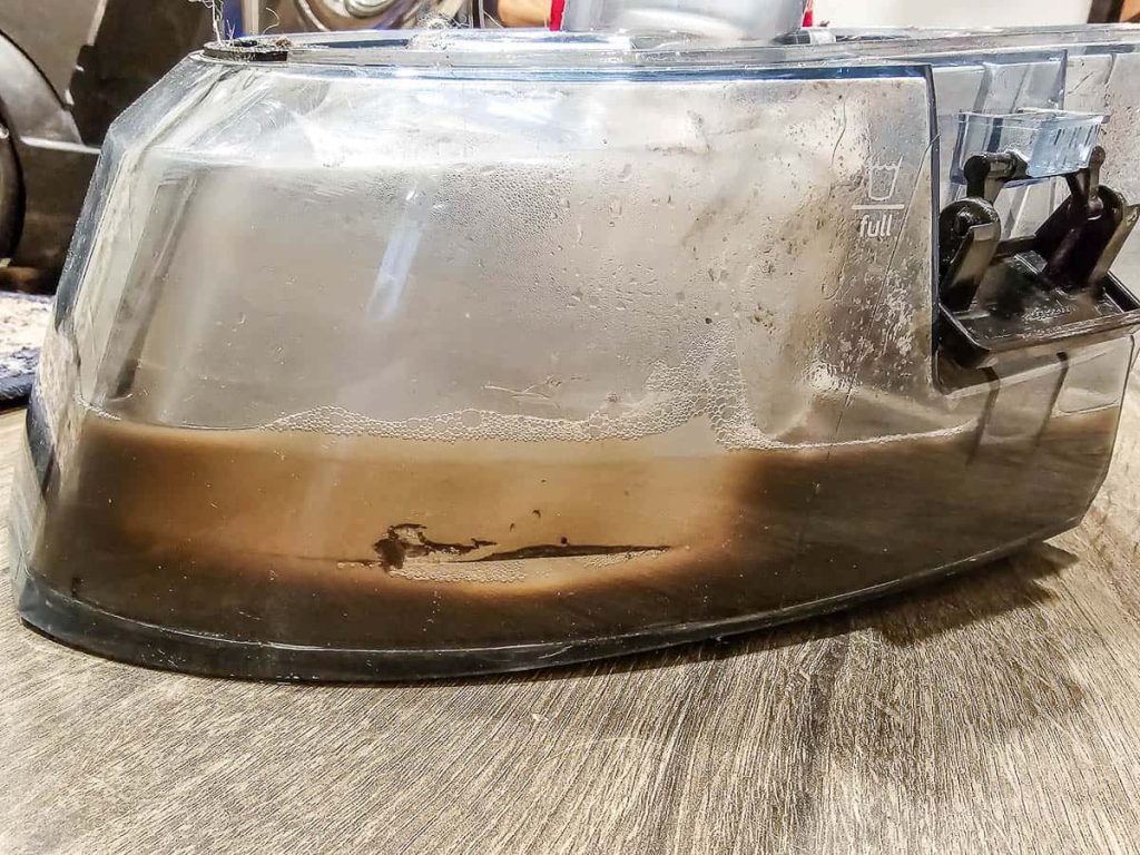 The photo shows a dirty water extracted from the carpet cleaner.

