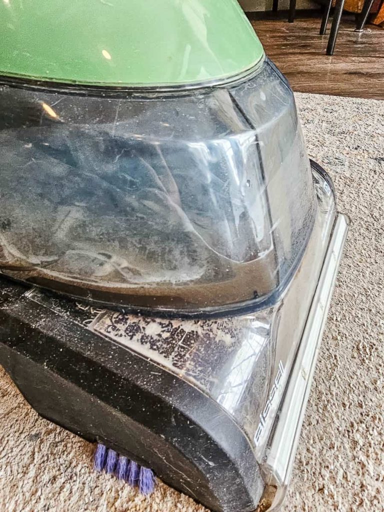 A close-up shot showcases the carpet cleaner in action.