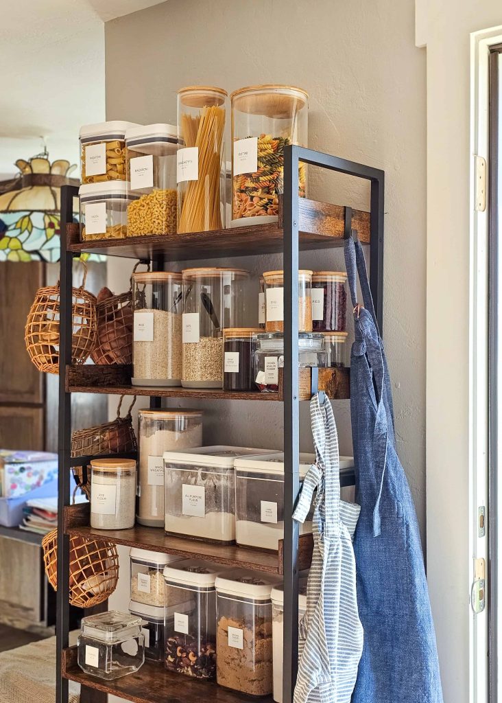 A shelving unit designed for pantry use, adorned with various food items neatly arranged on its surfaces