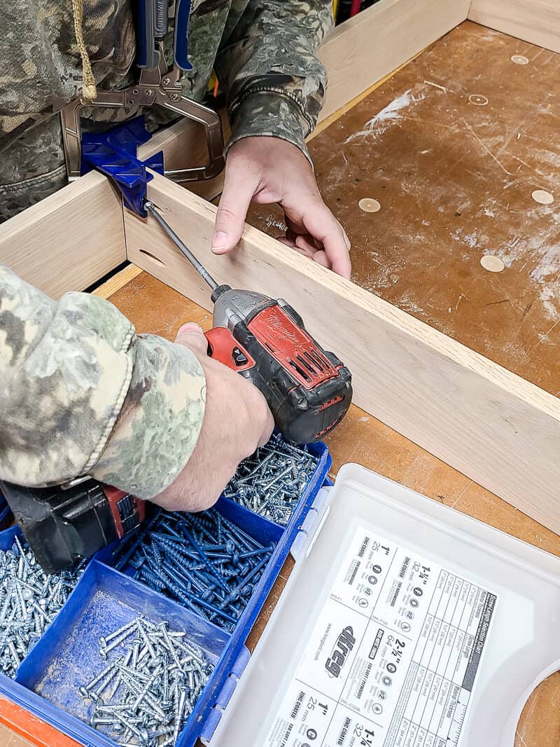 A person is assembling the sofa table.
