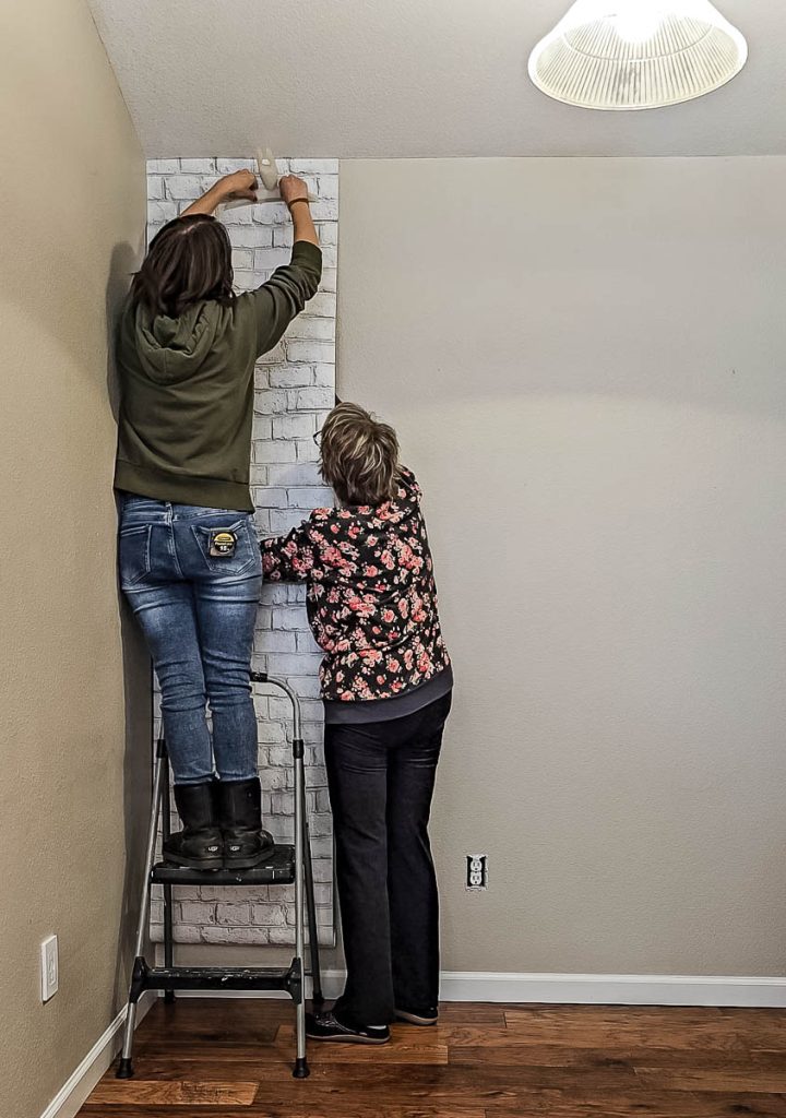 The wallpaper is carefully pasted onto the wall during installation.