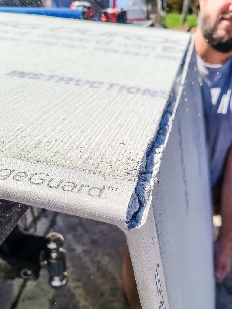close-up photo of cutting cement board in using snap method.