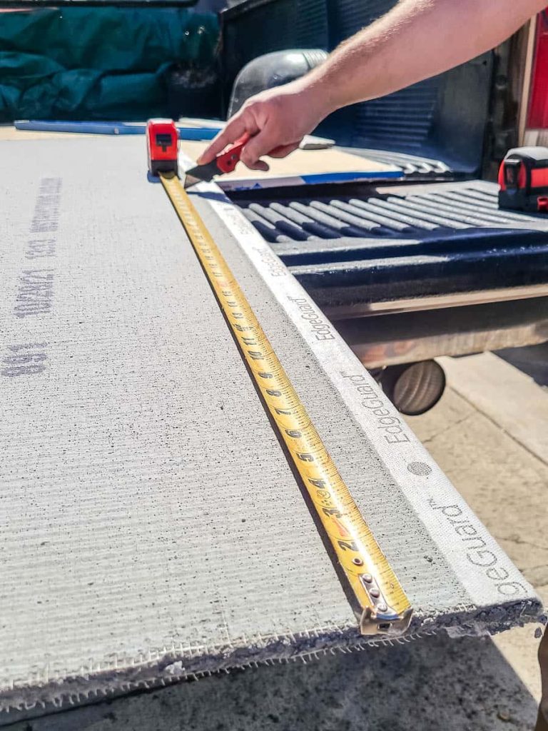 Photo of cement board before it was cut, showing measurements.