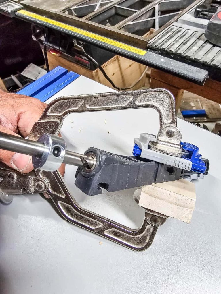 A person is utilizing a Kreg pocket hole jig to assemble a Chicknic Table.