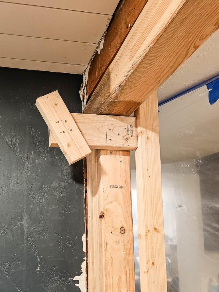 Makeshift cradles made with 2x4s to help lift up the large header during installation
