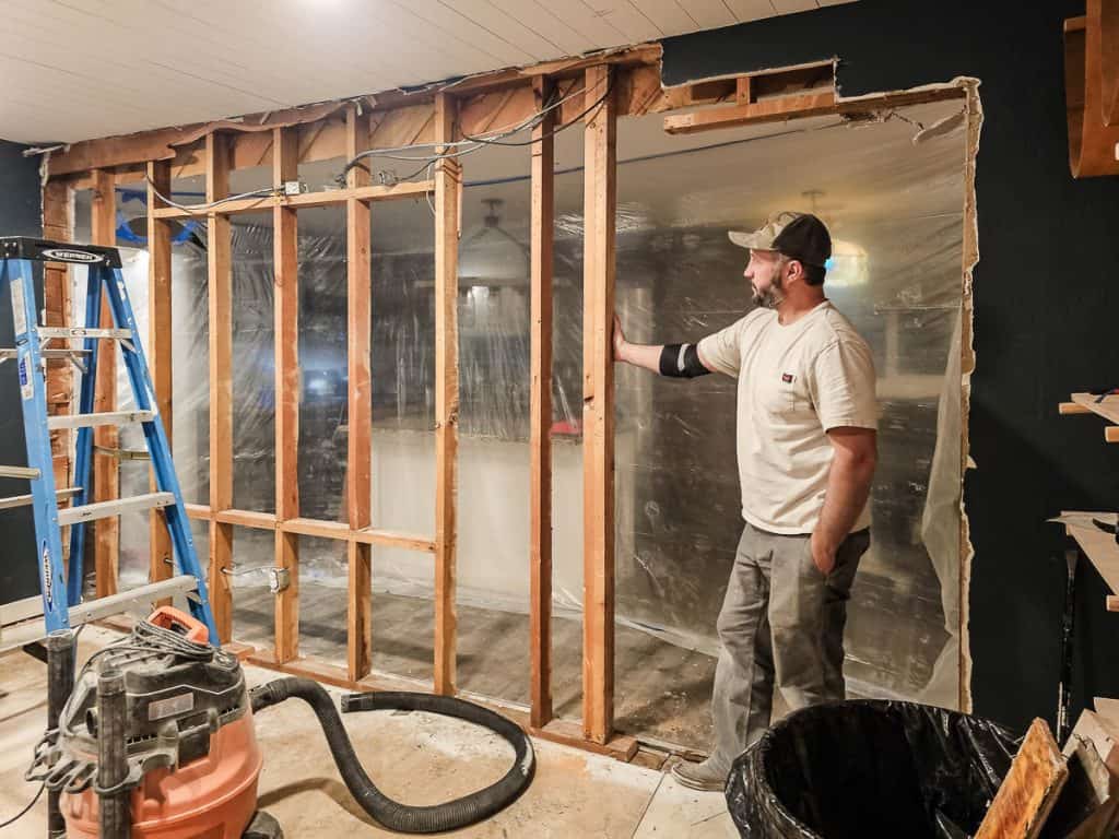 Interior studs revealed on wall that is going to be removed to create open concept for dining room 