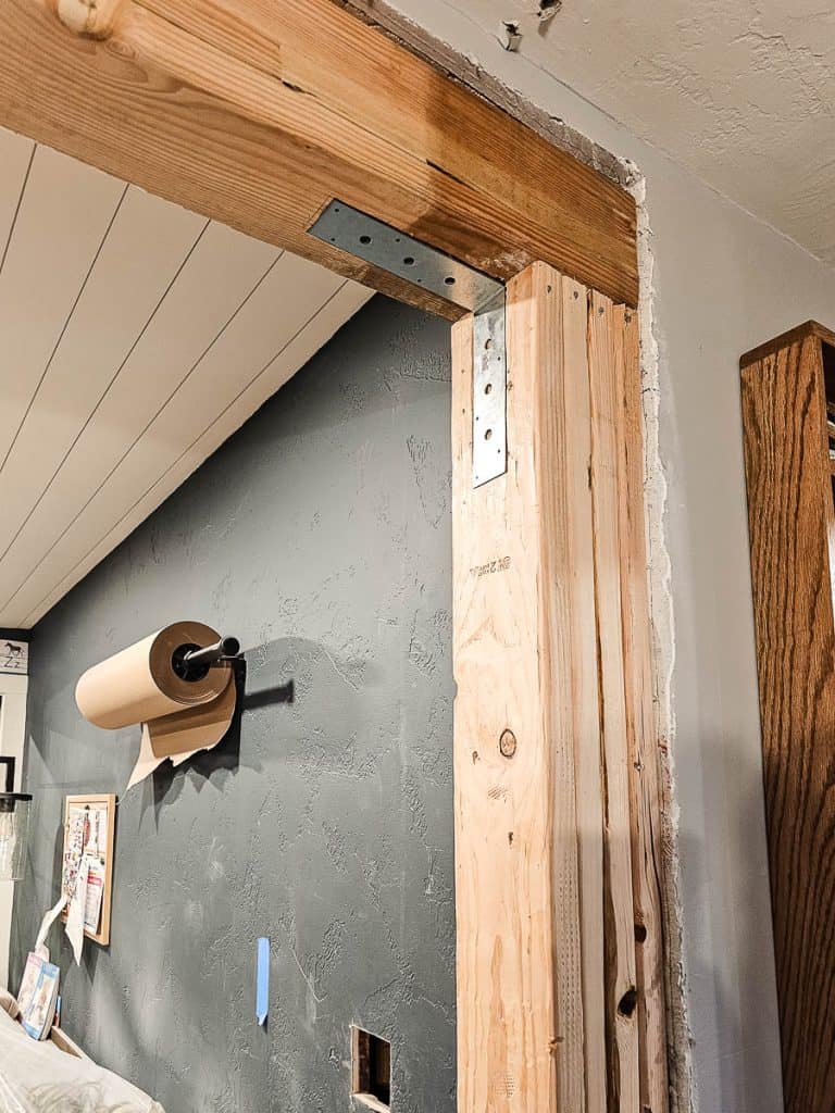 Steel corner L brackets for wall studs and header beam after removing wall