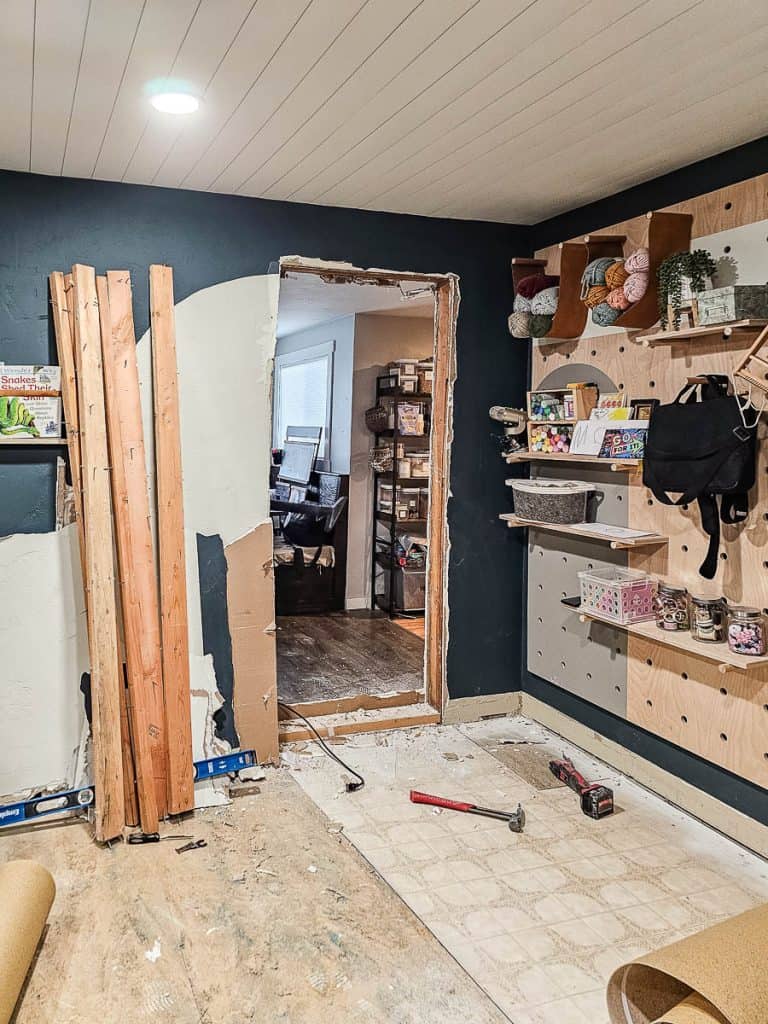 Opening doorway from home office to kitchen with renovation debris