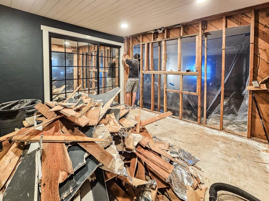 A photo capturing the process of tearing down two load-bearing walls to transform the space into an open-concept layout.