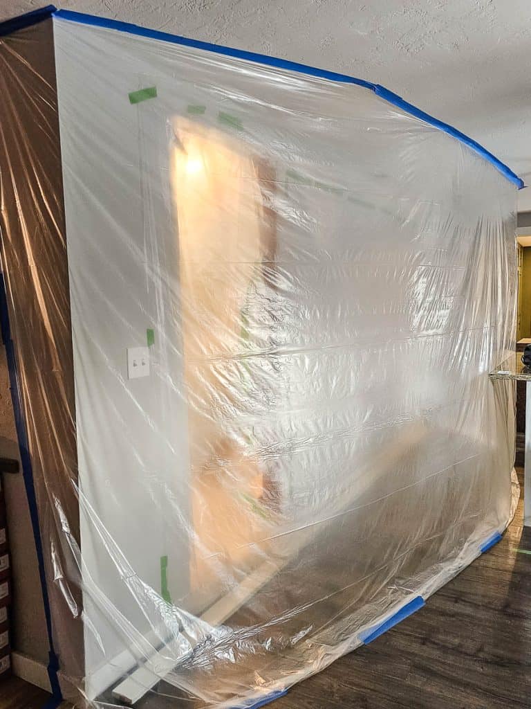 Walls of plastic sheeting taped to ceiling and floor to help contain the dust from demolition and removing walls during a renovation