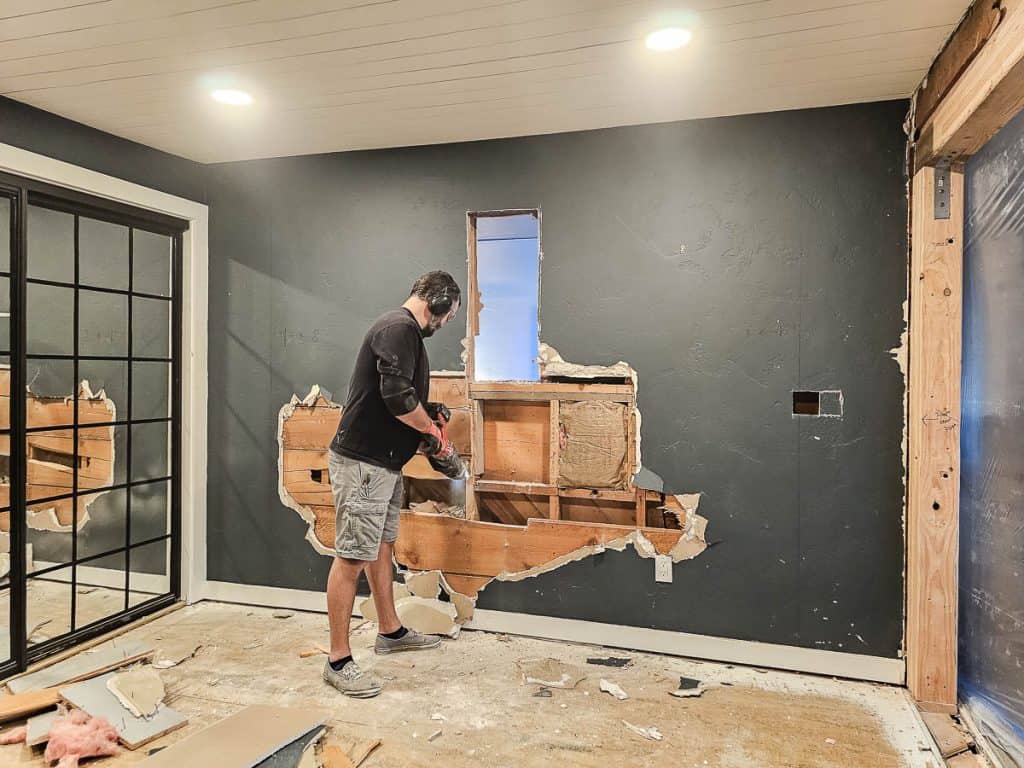 Drywall pulled back on the wall before taking down