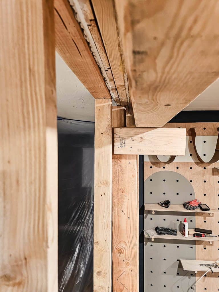 Large header beam being added to wall after removing to create open concept
